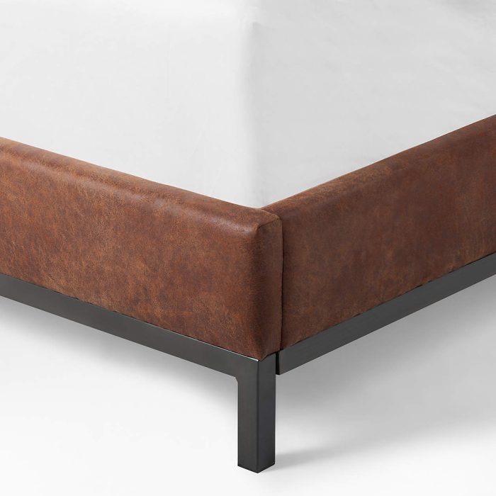the brown faux leather bed can be positioned in a variety of ways to suit your space.